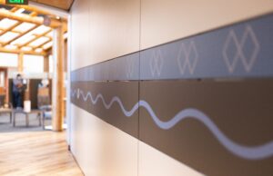 Hallway wall with blue and black patterns on it.