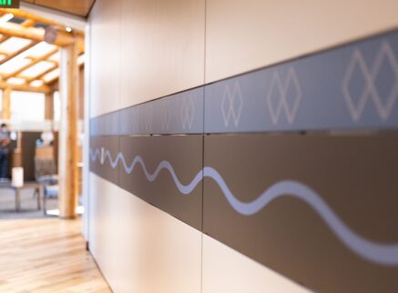 Hallway wall with blue and black patterns on it.